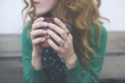 Close-up of young woman with coffee