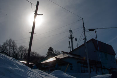 Low angle view of buildings against sky during winter