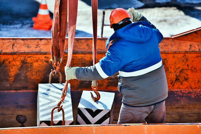 Rear view of man working in factory