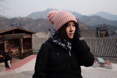 Young woman standing on snow covered mountain