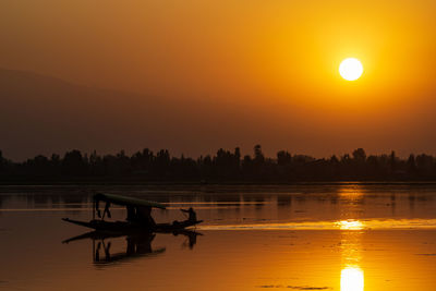 Scenic view of lake against sky during sunset