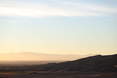 Scenic view of desert against sky during sunset