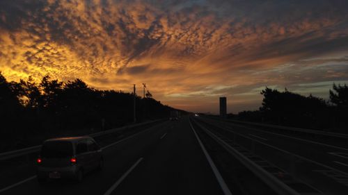 Railroad tracks against sky during sunset