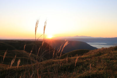 Scenic view of land against sky during sunset