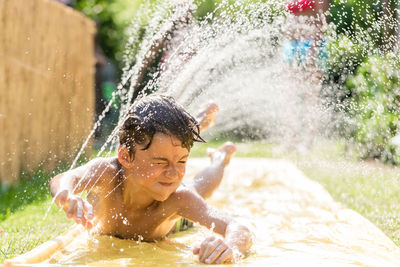 Close-up of boy splashing water