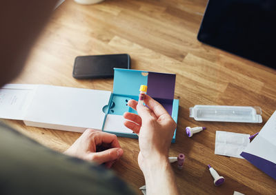 High angle view of man reading book on table
