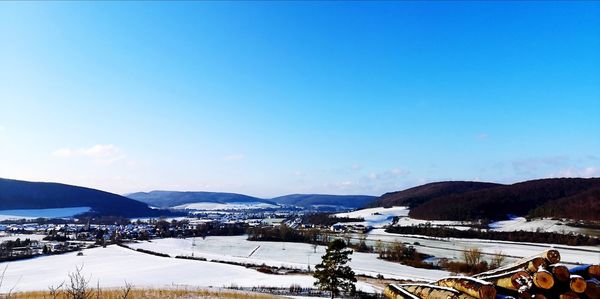 Scenic view of snowcapped mountains against blue sky