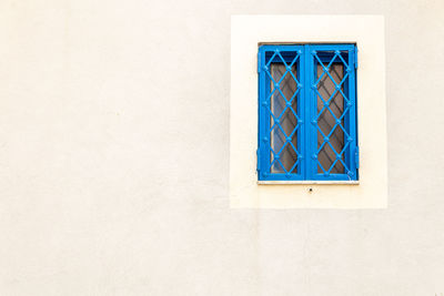 Close-up of blue window on wall