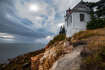 Building by sea against sky