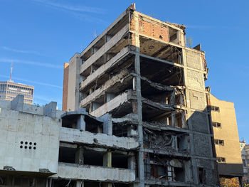 Low angle view of old building against blue sky