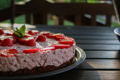 Close-up of strawberries on cheesecake in plate
