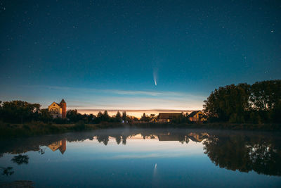 Scenic view of lake against sky at night