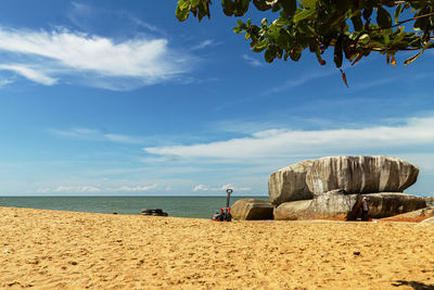 Scenic view of beach against blue sky