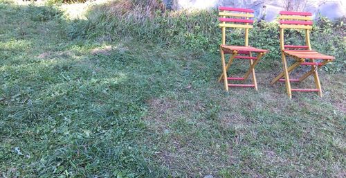 High angle view of empty chairs on field