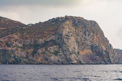 Scenic view of sea and mountains against sky