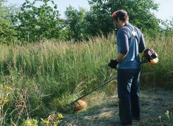 Rear view of man working on field