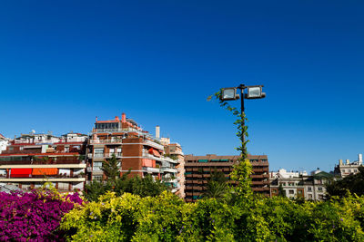 Low angle view of buildings against clear blue sky