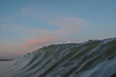 Scenic view of beach against sky during full moon