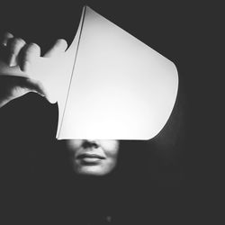 Close-up of man against black background