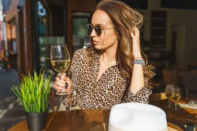 Young woman drinking glasses on table