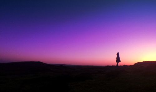 Silhouette of woman at sunset