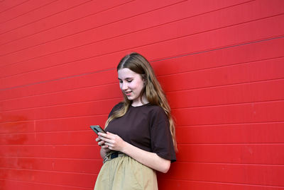 Portrait of young woman using mobile phone