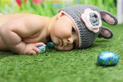 Cute baby lying on grass