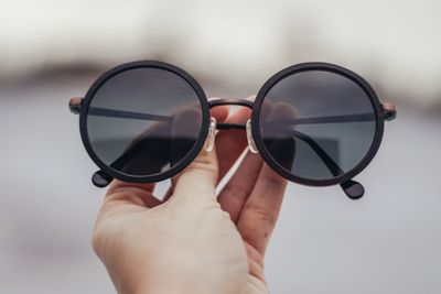 Close-up of hand holding eyeglasses