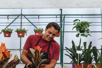 Young man and potted plants