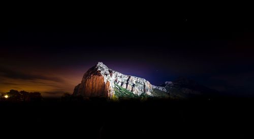 Scenic view of mountain against sky at night