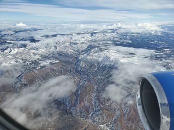 Aerial view of landscape seen through airplane window