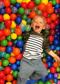 Portrait of smiling boy playing with balloons