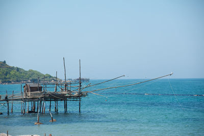 View of calm sea against clear blue sky