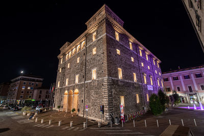 Low angle view of illuminated building at night