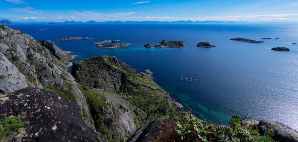 Panoramic view of small islands in the artic sea and mountains profile over the horizon