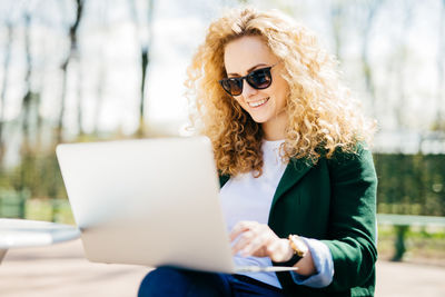 Young woman using mobile phone outdoors