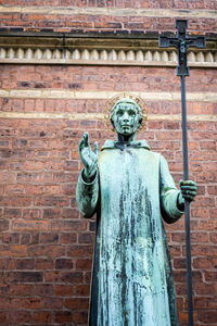 Low angle view of statue against wall