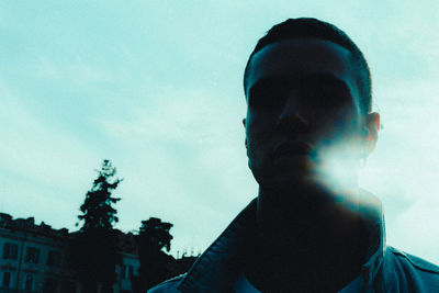 Low angle portrait of silhouette man against sky