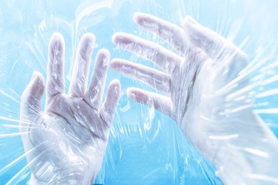 Close-up of human hands holding plastic