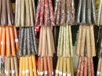 Full frame shot of spices hanging in plastic bags for sale at market