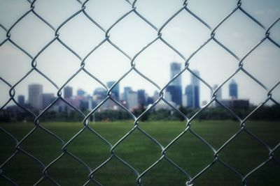 Close-up of chainlink fence against sky