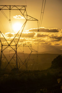 Towers of high voltage cables in an autumn sunset in the fields of the penedes region 