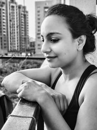 Portrait of smiling woman sitting in city