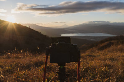 Camera on tripod against landscape