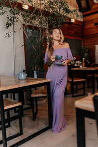 Portrait of pregnancy young woman standing in café 