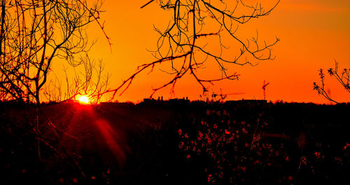 Silhouette landscape against sky during sunset