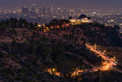 High angle view of city lit up at night