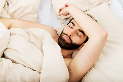 High angle view of woman sleeping on bed