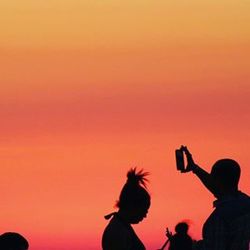 Silhouette of woman at sunset