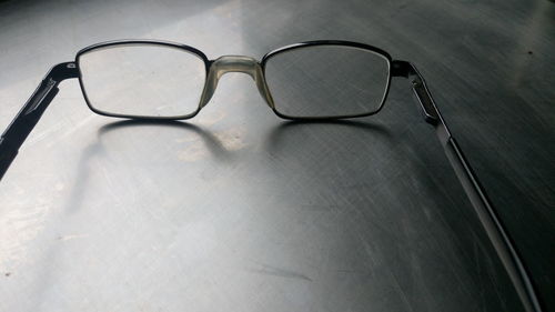 Cropped image of eyeglasses on table